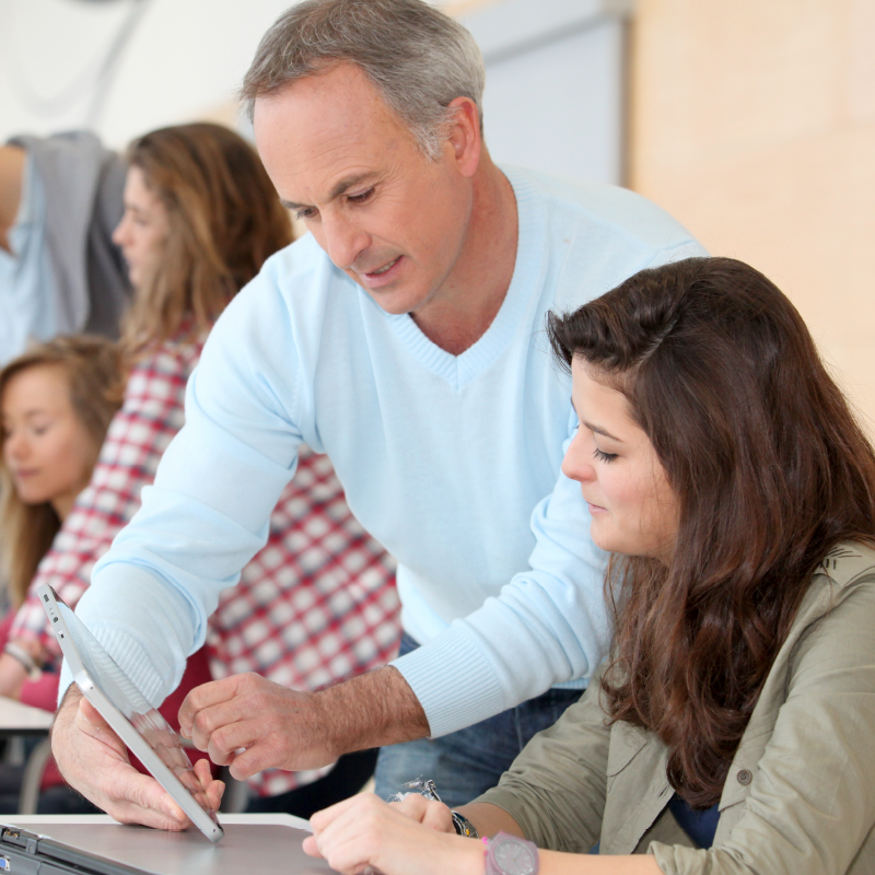 Two people reading an iPad about Educator Resources